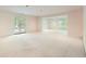 Spacious living room featuring neutral carpet, recessed lighting, and french doors to the exterior at 3801 Bays Ferry Trl, Marietta, GA 30062
