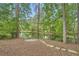 Peaceful pond with lush trees and a stone walkway at 3801 Bays Ferry Trl, Marietta, GA 30062