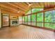 Vaulted ceiling, ceiling fans, and stone fireplace make this screened porch a relaxing retreat at 3801 Bays Ferry Trl, Marietta, GA 30062