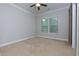 Bright bedroom featuring carpet and a barn-style sliding door at 569 Mirrormont Se Dr, Smyrna, GA 30080