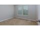 Neutral bedroom featuring plush carpet, a window, and an inviting atmosphere at 569 Mirrormont Se Dr, Smyrna, GA 30080