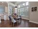 Bright dining room with hardwood floors, modern light fixture, and large windows at 569 Mirrormont Se Dr, Smyrna, GA 30080