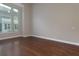 Sunlit living room featuring hardwood floors and large windows at 569 Mirrormont Se Dr, Smyrna, GA 30080