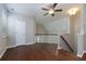 Bright loft space with hardwood floors, ceiling fan, and staircase at 569 Mirrormont Se Dr, Smyrna, GA 30080