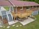 Backyard view of a wooden deck with stairs leading down to a stone patio, and mature landscaping at 3471 Elgin Dr, Decatur, GA 30032