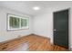 Bedroom featuring hardwood floors, white walls, and a window providing ample natural light at 3471 Elgin Dr, Decatur, GA 30032