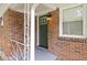 Close-up of a brick home featuring a decorative front door and adjacent window with blinds at 3471 Elgin Dr, Decatur, GA 30032