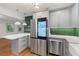 Well-lit kitchen with stainless steel appliances, green backsplash and kitchen island at 3471 Elgin Dr, Decatur, GA 30032