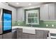 Bright kitchen with stainless steel appliances, light grey cabinets, and a window over the sink at 3471 Elgin Dr, Decatur, GA 30032