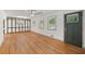 Inviting living room with hardwood floors, decorative paneling, and a large window view at 3471 Elgin Dr, Decatur, GA 30032