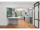 Bright open concept kitchen area featuring an island with seating, hardwood floors and view to appliances at 3471 Elgin Dr, Decatur, GA 30032