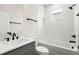 Modern bathroom with a white bath tub and dark fixtures at 1122 W Marietta St, Atlanta, GA 30318