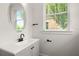 Bathroom featuring a single sink vanity, modern fixtures, and a bright window at 1122 W Marietta St, Atlanta, GA 30318