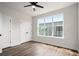 Bedroom featuring hardwood floors, a ceiling fan, and a view of the neighborhood at 1122 W Marietta St, Atlanta, GA 30318