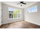 Bedroom with hardwood floors and a ceiling fan with a view of the neighborhood at 1122 W Marietta St, Atlanta, GA 30318