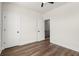 Bedroom featuring hardwood floors, white walls, and two doors, one for closet and another for hallway at 1122 W Marietta St, Atlanta, GA 30318