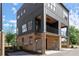 Modern townhome with sleek metal siding, brick foundation, and private balconies, offering stylish urban living at 1122 W Marietta St, Atlanta, GA 30318