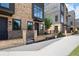 Exterior view of a townhome featuring a brick facade, dark accents, and a well-maintained sidewalk at 1122 W Marietta St, Atlanta, GA 30318
