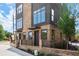 Townhome exterior showcasing the brickwork, black metal accents, and professional landscaping at 1122 W Marietta St, Atlanta, GA 30318