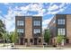 Modern townhouse with a brick facade, dark metal accents, and large windows on a sunny day at 1122 W Marietta St, Atlanta, GA 30318