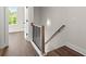 An entrance hallway with a hardwood floor and a wooden banister staircase at 1122 W Marietta St, Atlanta, GA 30318
