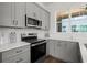 Well lit kitchen featuring stainless steel appliances, white countertops, and light gray cabinetry at 1122 W Marietta St, Atlanta, GA 30318