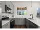 Efficient kitchen featuring gray cabinets, stainless appliances, and ample natural light at 1122 W Marietta St, Atlanta, GA 30318