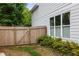 Side yard featuring a wood fence and lush greenery, offering a private outdoor space at 1378 Lochland Se Rd, Atlanta, GA 30316