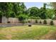 Lush backyard featuring green lawn, a fire pit, shed and mature landscaping at 1378 Lochland Se Rd, Atlanta, GA 30316