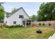 Expansive backyard featuring a fire pit, wooden fence, and a covered patio for outdoor enjoyment at 1378 Lochland Se Rd, Atlanta, GA 30316