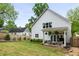 Expansive backyard view showing manicured lawn, patio, privacy fence, and a view of the home's exterior at 1378 Lochland Se Rd, Atlanta, GA 30316