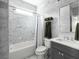 Elegant bathroom showcasing marble tile, a shower-tub combination, and modern fixtures at 1378 Lochland Se Rd, Atlanta, GA 30316