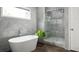 Sleek bathroom with a stand-alone tub and glass-enclosed shower, showcasing modern design at 1378 Lochland Se Rd, Atlanta, GA 30316