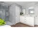 Bright bathroom showcases a modern glass shower and a double sink vanity for added convenience at 1378 Lochland Se Rd, Atlanta, GA 30316