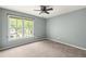 Bright, empty bedroom with large window and neutral carpet at 1378 Lochland Se Rd, Atlanta, GA 30316