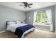 Cozy bedroom featuring a ceiling fan and a large window with natural light at 1378 Lochland Se Rd, Atlanta, GA 30316