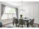 Stylish dining room featuring a modern light fixture, paneled walls, and elegant curtains at 1378 Lochland Se Rd, Atlanta, GA 30316