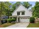 Charming two-story home featuring a white exterior, attached garage, and well-manicured landscaping at 1378 Lochland Se Rd, Atlanta, GA 30316