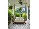 Relaxing front porch featuring a porch swing, ceiling fan, and patterned tile, perfect for enjoying the outdoors at 1378 Lochland Se Rd, Atlanta, GA 30316