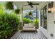 Relaxing front porch featuring a porch swing, ceiling fan, and patterned tile, perfect for enjoying the outdoors at 1378 Lochland Se Rd, Atlanta, GA 30316