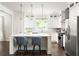Elegant kitchen with stainless steel appliances, a large island, and stylish pendant lighting at 1378 Lochland Se Rd, Atlanta, GA 30316