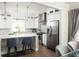Bright kitchen with white cabinets, stainless steel appliances, and a center island with seating at 1378 Lochland Se Rd, Atlanta, GA 30316