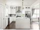 Well-lit kitchen with white cabinets, a marble backsplash, stainless steel appliances, and an island at 1378 Lochland Se Rd, Atlanta, GA 30316