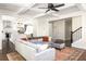 Spacious living room with a large sofa, decorative ceiling, and open access to the kitchen at 1378 Lochland Se Rd, Atlanta, GA 30316
