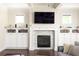 Bright living room with fireplace, built-in cabinets, and a large TV screen above the mantel at 1378 Lochland Se Rd, Atlanta, GA 30316