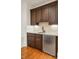 Basement bar area with dark cabinets, granite countertop, and stainless steel refrigerator at 2017 Harts Mill Ne Rd, Chamblee, GA 30341