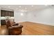 Spacious basement entertainment area with leather recliners, hardwood floors, and bar at 2017 Harts Mill Ne Rd, Chamblee, GA 30341