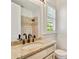 Well-lit bathroom with granite countertop, double vanity, and tiled shower at 2017 Harts Mill Ne Rd, Chamblee, GA 30341