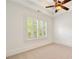 Bedroom with neutral carpet, white walls, ceiling fan and plantation shutters allowing for natural light at 2017 Harts Mill Ne Rd, Chamblee, GA 30341