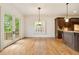 Dining area features hardwood floors, French doors, and dark wood cabinets at 2017 Harts Mill Ne Rd, Chamblee, GA 30341